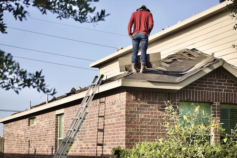 Professional roofer working on a residential roof in Grove